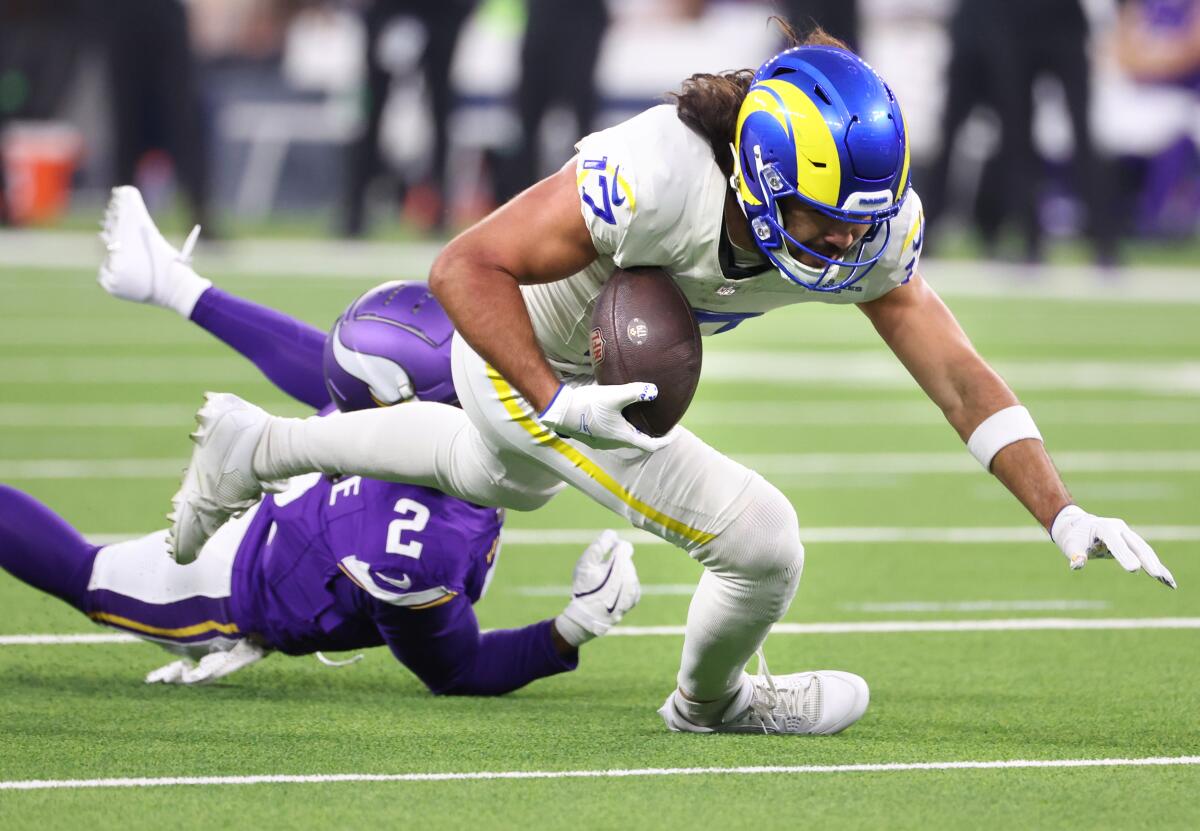 Rams receiver Puka Nacua tries to escape the pursuit of Vikings cornerback Stephon Gilmore after making a catch. 