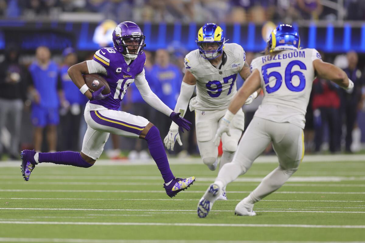 Rams Michael Hoecht (97) and Christian Rozeboom (56)  pursue Vikings wide receiver Justin Jefferson. 