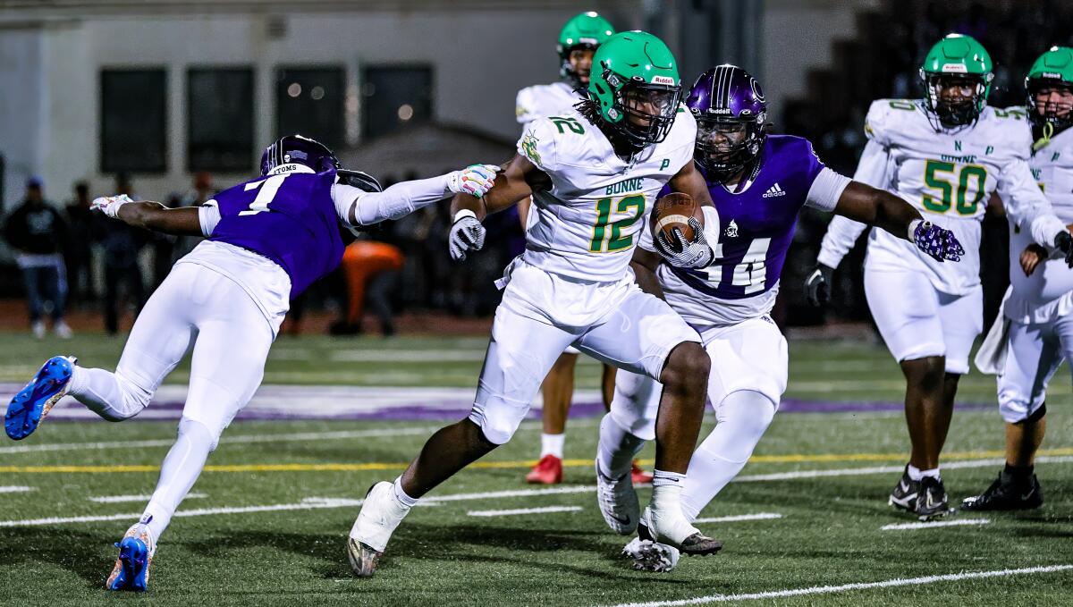 Freshman running back Derrick Jackson picks up yards during a nonleague defeat of L.A. Cathedral.