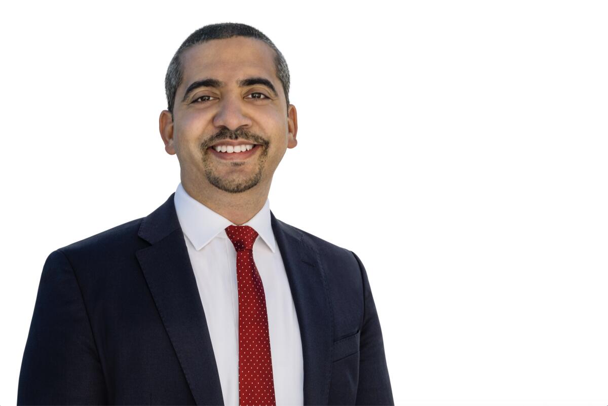 Mehdi Hasan smiles in a portrait.