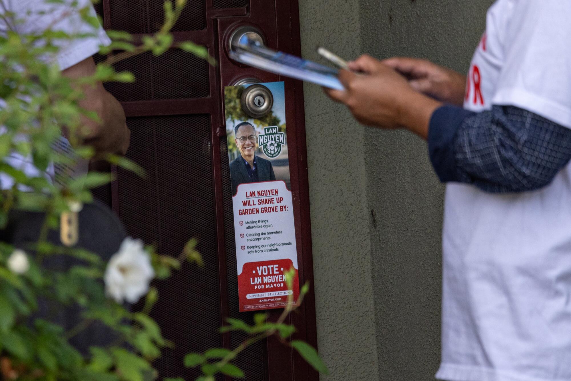 A campaign flier is left on a door.