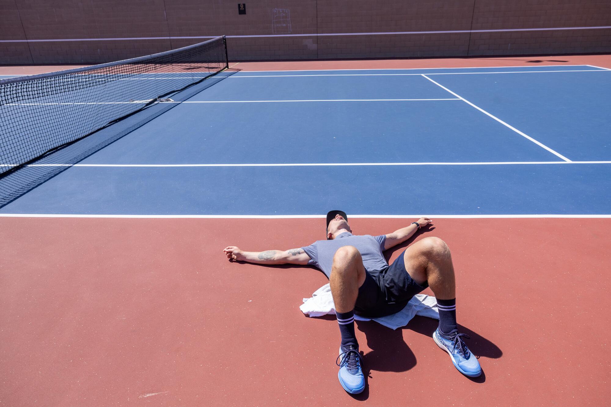 Karue Sell relaxes after training on the courts at Redondo Union High School.