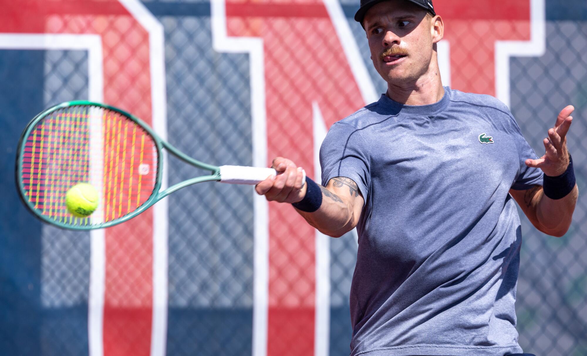 Karue Sell hits a shot while training in Redondo Beach.