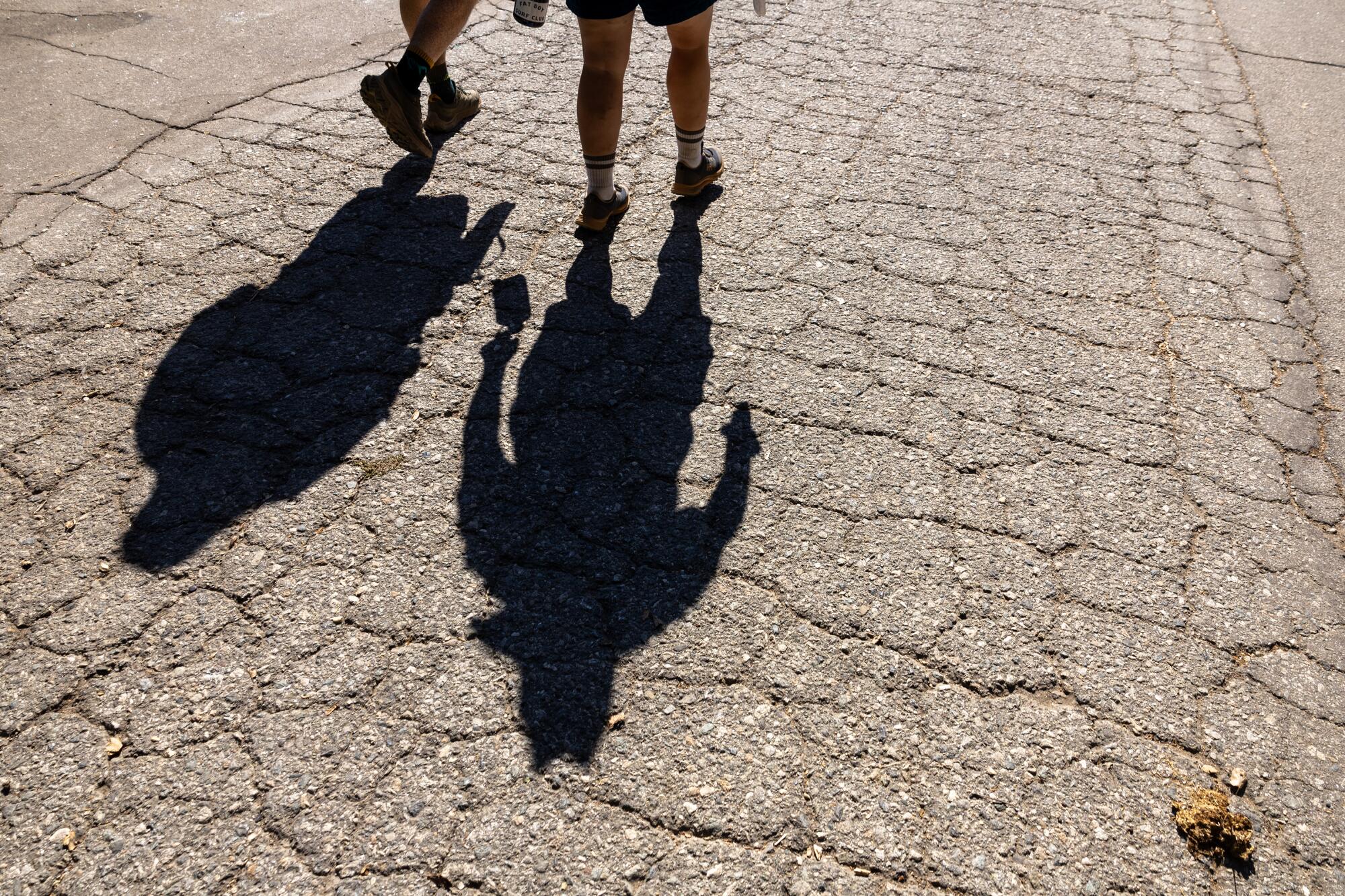 Shadows are casts as comedian Allan McLeod walks and talks with actress Betsy Sodaro in Pasadena.