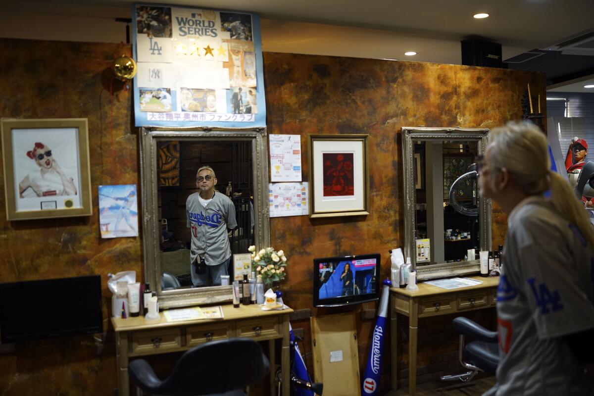 A man is reflected in a beauty salon mirror. 