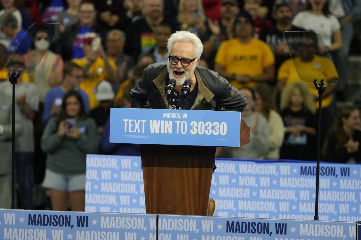 A man talks at a lectern.