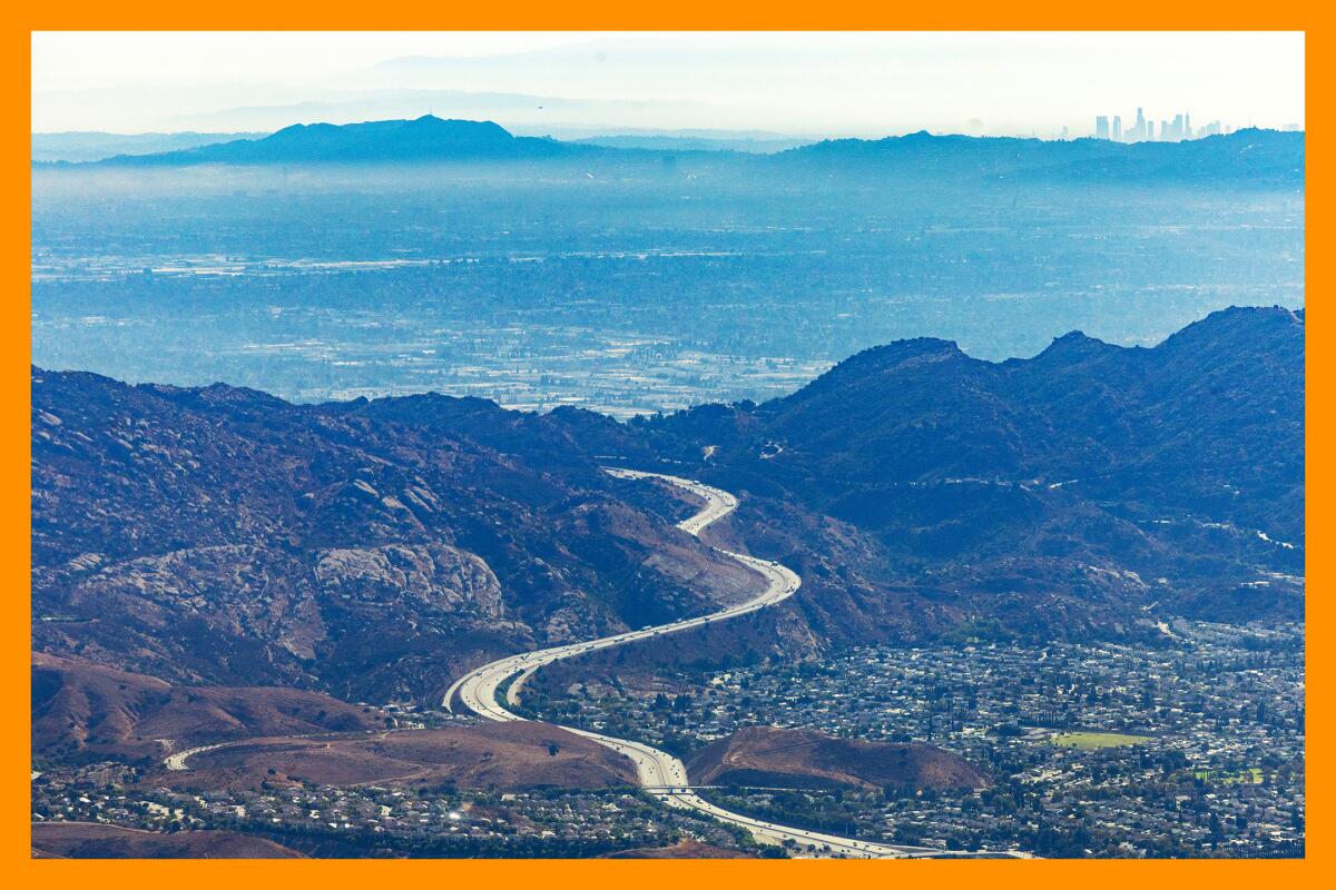 An aerial view of Los Angeles County with sprawling mountains amid thousands of homes