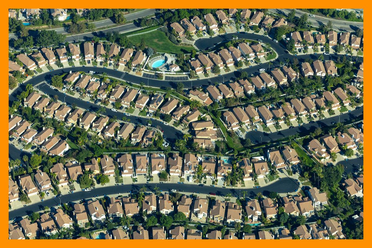 Curved streets full of similar homes in a development with cul-de-sacs and trees, seen from above