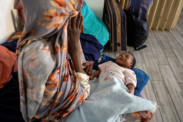 Zeinab from Sudan holds her newborn baby girl in the temporary shelter for migrants at St. Joseph Church in Beirut, Lebanon October 1, 2024. REUTERS/Louisa Gouliamaki