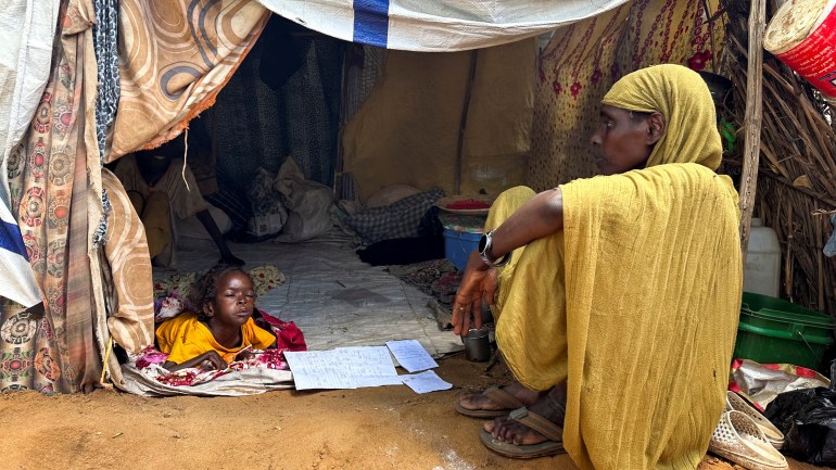 A displaced Sudanese woman rests inside a shelter at Zamzam camp, in North Darfur, Sudan, August 1, 2024. REUTERS/Mohamed Jamal Jebrel/File Photo