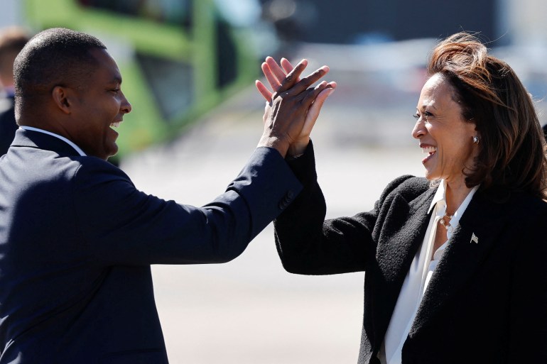 Don Davis high-fives Kamala Harris as they meet outdoors in Greenville, North Carolina