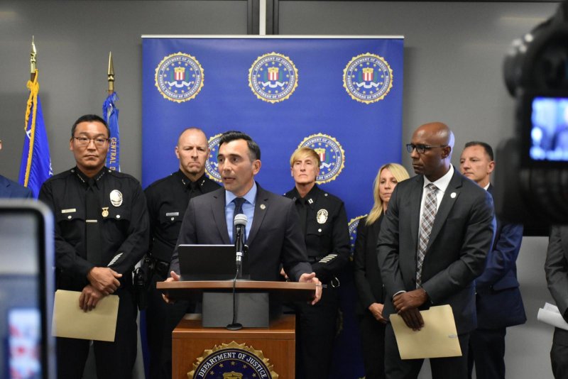 U.S. Attorney Martin Estrada for the Central District of California (C) on Wednesday, October 2, announces a 76-count indictment against 68 alleged members and associates of the San Fernando Valley Peckerwoods, a White supremacist gang. Photo courtesy of U.S. Attorney's Office for the Central District of California/Facebook