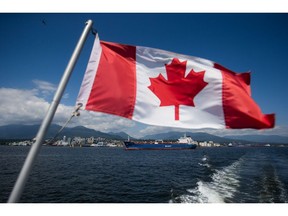 A Canadian flag flies from a Harbour Authority patrol boat as the Nord Steady oil and chemical tanker is guided by tugboats out of the Port of Vancouver in Vancouver, British Columbia, Canada, on Tuesday, July 11, 2017. Statistics Canada (STCA) is scheduled to release International Trade Balance Figures On Aug. 4. Photographer: Darryl Dyck/Bloomberg