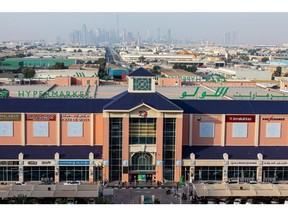 Skyscrapers stand on the city skyline beyond a Lulu hypermarket, operated by Lulu Group International, during the coronavirus lockdown in Dubai, United Arab Emirates, on Thursday, April 23, 2020. An investment firm backed by a member of Abu Dhabi's royal family agreed to buy a stake worth just over $1 billion in LuLu Group International, which runs one of the Middle East's largest hypermarket chains, according to people familiar with the matter.