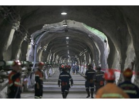 Miners walk through a tunnel underground at the Cukaru Peki copper and gold mine, operated by Zijin Mining Group Co., in Bor, Serbia, on Friday, Aug. 25, 2023. China's Zijin is developing plans to expand its copper mine in eastern Serbia due to demand for the metal considered vital to the global energy transition -- an effort that could cost billions of dollars. Photographer: Oliver Bunic/Bloomberg