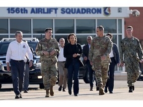 Kamala Harris walks with members of the US Armed Forces and North Carolina Governor Roy Cooper after being briefed on Hurricane Helene recovery operations in Charlotte on Oct. 5.  Photographer: Mario Tama/Getty Images