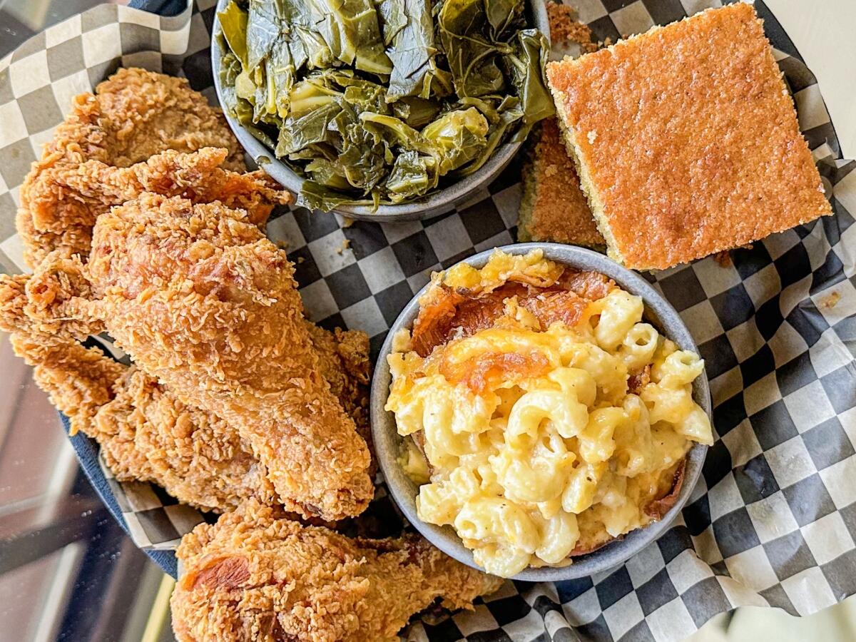 Fried chicken with collard greens, mac and cheese and cornbread at Minnie Bell's Soul Movement in San Francisco