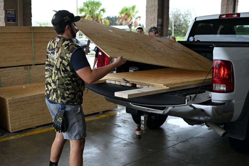 A Lowe's employee loads plywood into a truck for a local individual making final preparations as Hurricane Milton approaches Central Florida in Melbourne, Fla., on Wednesday. Photo by Joe Marino/UPI