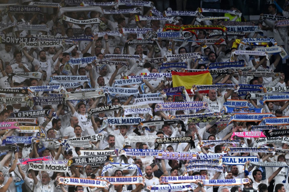 Real Madrid fans wear a wall of white shirts and flags