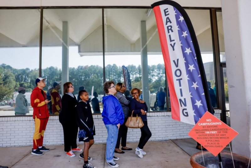 People wait in line to cast their ballots Tuesday during the first day of advanced voting in Georgia for the U.S. presidential election and other races at the main Dekalb County Voter Registration and Elections Office in Decatur, Georgia. Voters shattered turnout records for the first day with more than 300,000 ballots cast. Photo by Erik S. Lesser/EPA-EFE