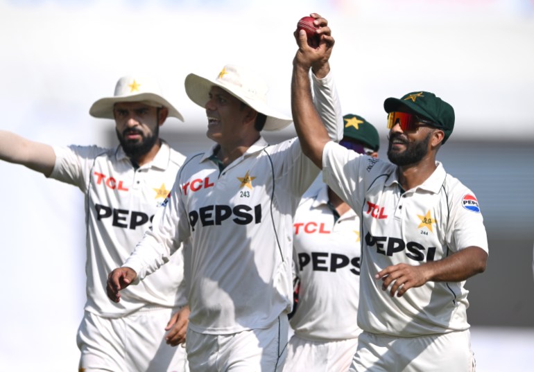 RAWALPINDI, PAKISTAN - OCTOBER 26: Pakistan bowlers Noman Ali (l) and Sajid Khan walk off with the innings ball after taking 10 wickets between them during day three of the 3rd Test Match between Pakistan and England at Rawalpindi Cricket Stadium on October 26, 2024 in Rawalpindi, Pakistan. (Photo by Stu Forster/Getty Images)