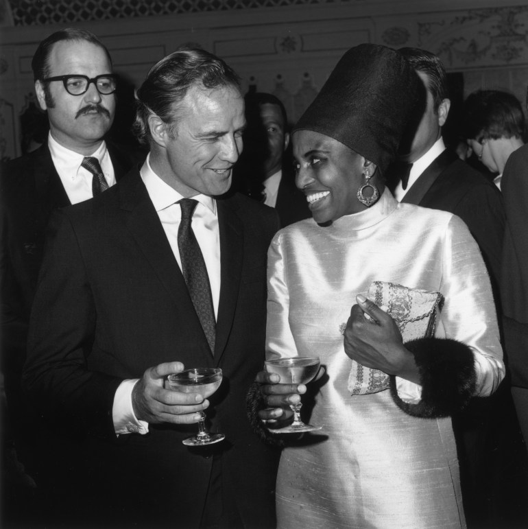 2nd April 1968: American actor Marlon Brando and South African singer Miriam Makeba holding champagne at her opening at the Cocoanut Grove, Los Angeles, California. (Photo by Max B. Miller/Fotos International/Getty Images)