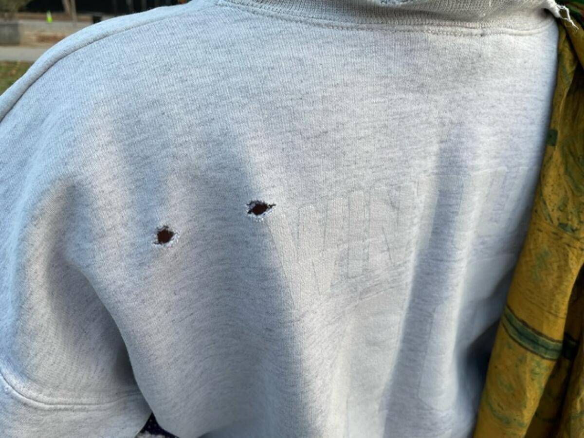 Holes in a sweatshirt left by falling debris during artist Cai Guo-Qiang's daytime fireworks.