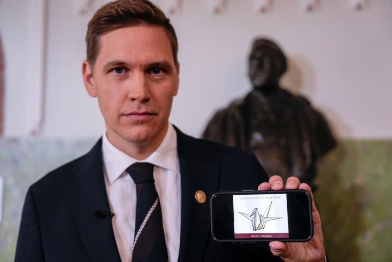 Chairman of the Norwegian Nobel Committee Jorgen Watne Frydnes poses with a picture of the Japanese organization Nihon Hidankyo, winner of the Nobel Peace Prize for 2024 at a press conference at the Nobel Institute in Oslo, Norway, on Friday. Photo by Javad Parsa/EPA-EFE