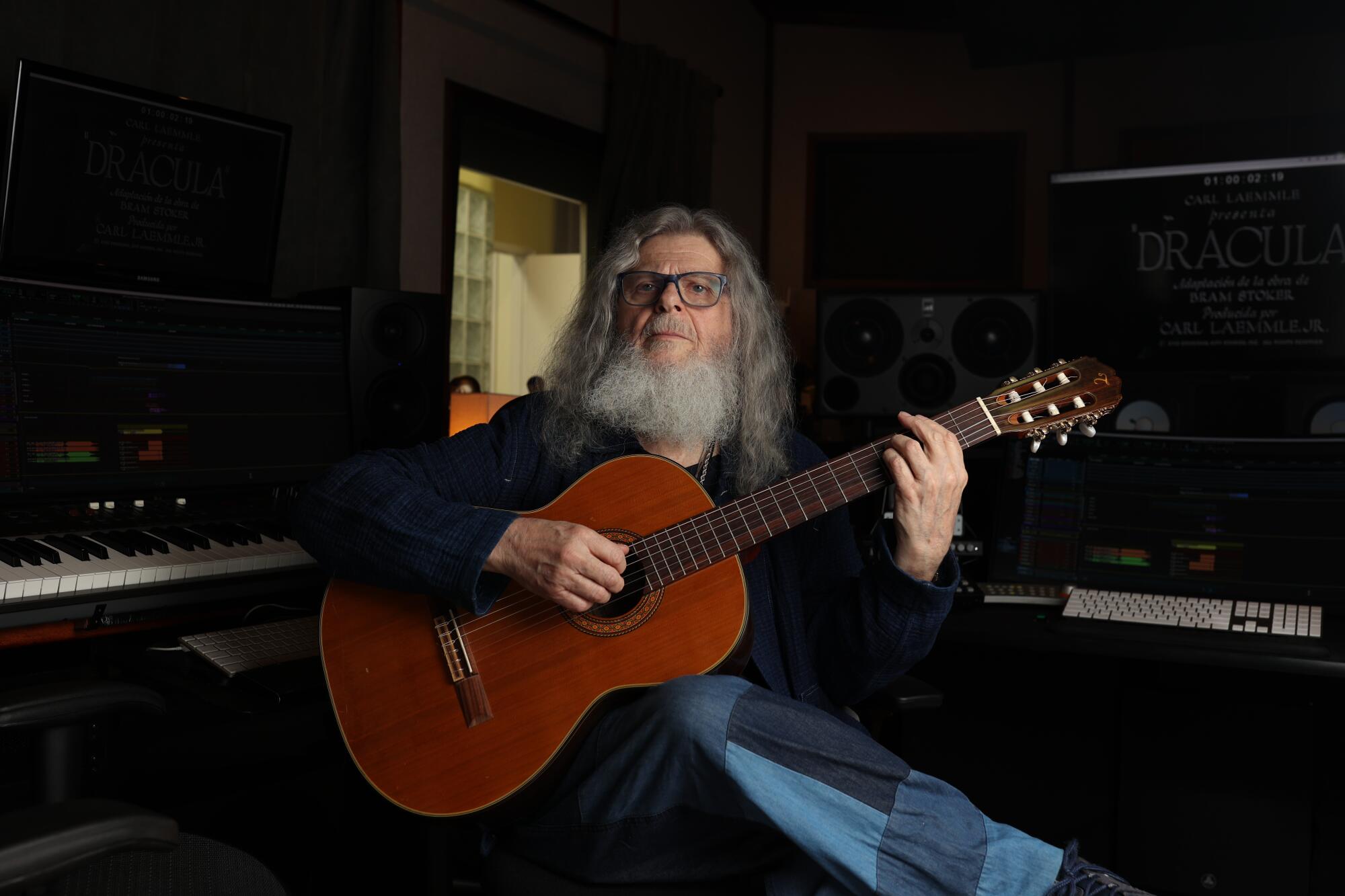 Gustavo Santaolalla poses for a portrait in his studio with a acoustic guitar 