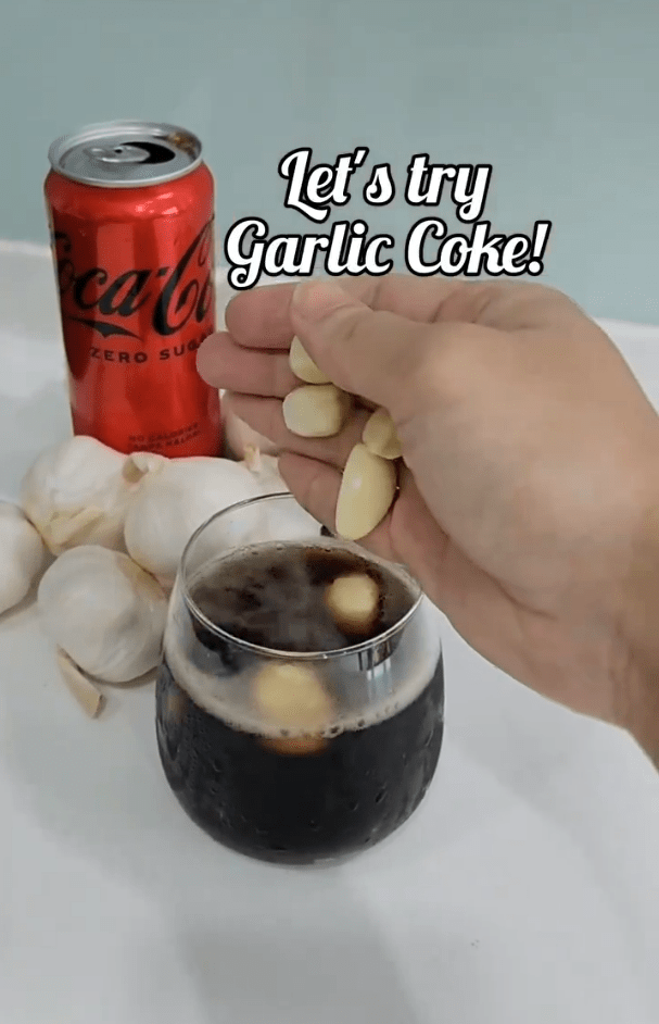 Lee trying a glass of Coke with cloves of garlic