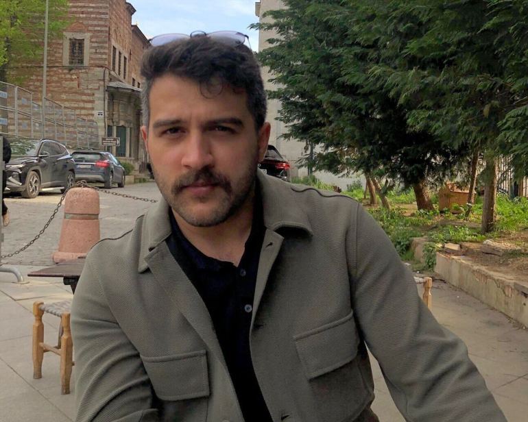 Muhammed Enes sitting at a coffee shop in Fatih, Istanbul. 