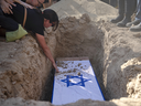 Rimon Buchshtab mourns during the funeral of her husband, Yagev Buchshtab, at a cemetery of the Kibbutz Nirim, Aug. 21, 2024. Buchshtab's body was one of six bodies of hostages, taken in Hamas' Oct. 7 attack, recovered by Israel's military during an operation in the Gaza Strip.