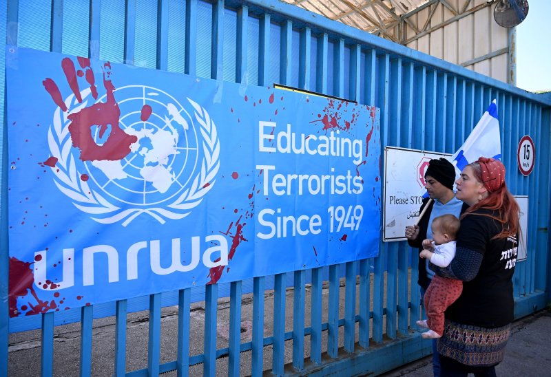 Israeli right-wing protesters look at a banner hung on the entrance to the UNRWA, the United Nations Relief and Works Agency for Palestine Refugees, headquarters in Jerusalem on Wednesday, March 20, 2024. On Monday, Israel's parliament moved to ban the work of the U.N. agency. File Photo by Debbie Hill/ UPI