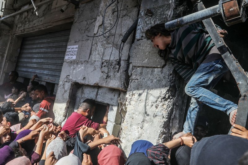 Israeli strikes around dawn Friday in Gaza's Khan Younis area killed at least 38 Palestinians, according to a Friday statement by the Palestinian Ministry of Health in Gaza. Dozens more were wounded. Palestinians crowd while queueing for bread outside a bakery in Khan Yunis in the southern Gaza Strip, Thursday. Photo by Anas Deeb/UPI