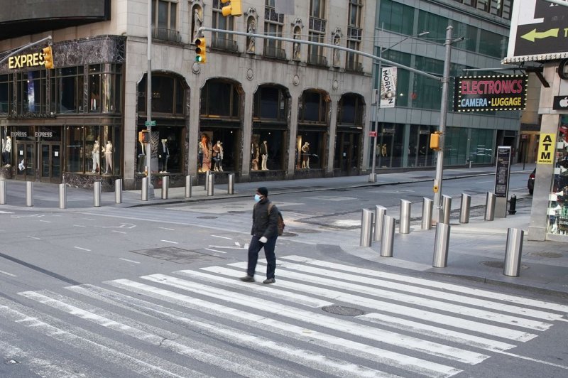 A pedestrian occupies a crosswalk on 7th Avenue in New York City (2020). Beginning in February, jaywalking won't be a crime in NYC. File Photo by John Angelillo/UPI