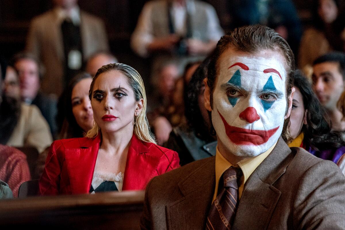 Two people in makeup sit during a courtroom trial.