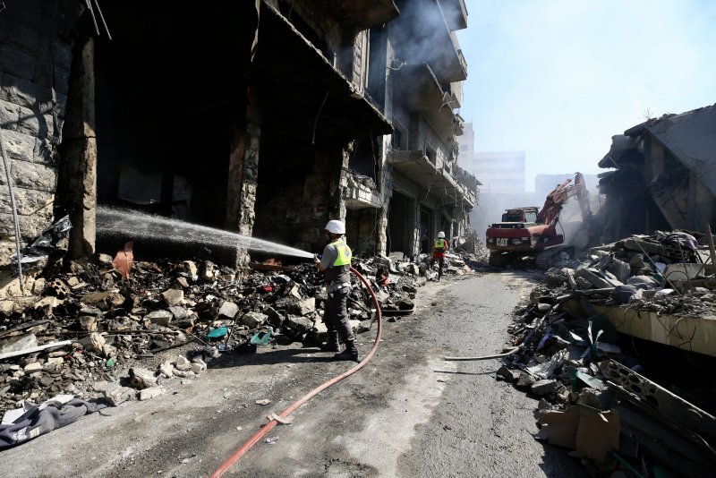 Rescuers work at the site of destroyed buildings following an Israeli military strike on a commercial market in Nabatieh, southern Lebanon, on Sunday. Photo by EPA-EFE