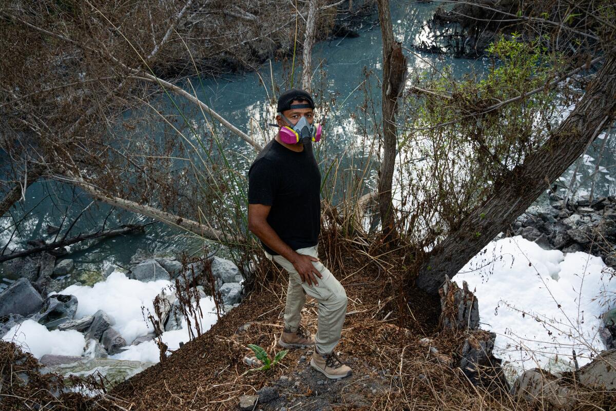 Ramon Chairez stands atop the bridge above the Tijuana River at Saturn Boulevard in San Ysidro.