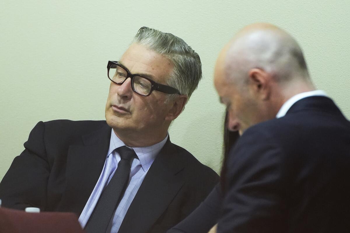 Actor Alec Baldwin, left, attends his trial in Santa Fe, N.M. (Ramsay de Give/Pool Photo via AP)