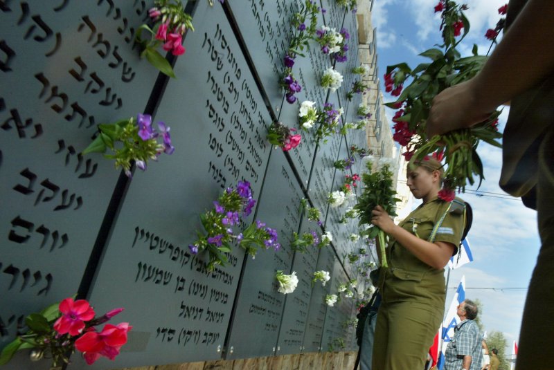 Israeli soldiers lay flowers at a war memorial center in Israel on the anniversary of the Yom Kippur War between Israel and, Syria and Egypt which began October 6, 1973. File Photo by Orel Cohen/UPI