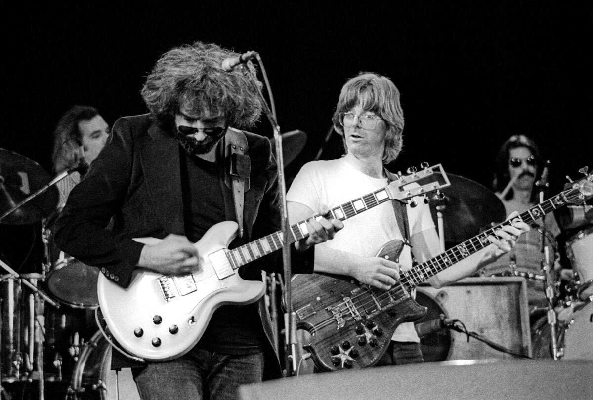 The Grateful Dead's Jerry Garcia, left, and Phil Lesh onstage in 1976 .