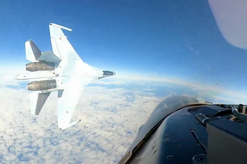 A Russian fighter flies dangerously close to a U.S. Air Force jet, patrolling off the coast of Alaska. The North American Aerospace Defense Command called the maneuver "unsafe, unprofessional and endangered all." Photo courtesy of NORAD