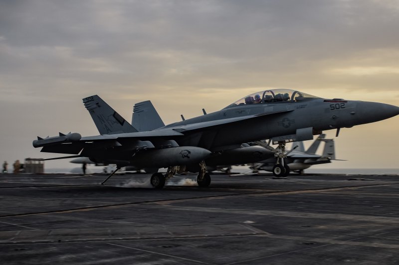 An E/A-18G Growler, assigned to the Cougars of Electronic Attack Squadron 139, lands on the flight deck of the aircraft carrier USS Theodore Roosevelt. Photo by U.S. Navy Mass Communication Specialist 3rd Class Alex Perlman