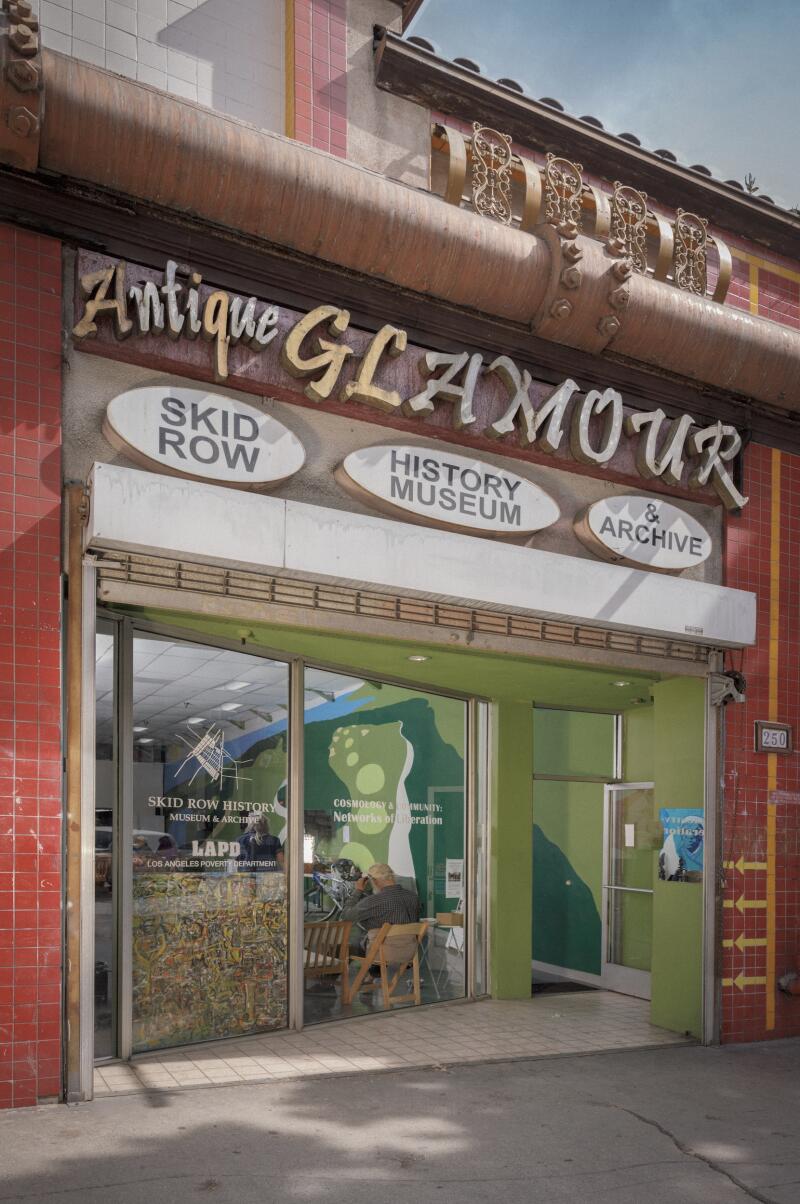 The storefront of the Skid Row History Museum and Archive, with the words "Antique" and "Glamour" above the door.