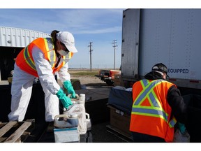 Unwanted pesticides and old livestock medications being dropped off and sorted at a collection site for safe disposal.