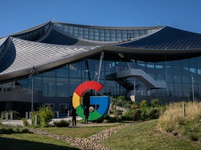 Visitors take a photograph in front of the 'G' logo outside the Google Bay View campus in Mountain View, California.