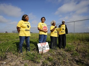 FILE - From left, Myrtle Felton, Sharon Lavigne, Gail LeBoeuf and Rita Cooper, members of RISE St. James, conduct a live stream video on property owned by Formosa in St. James Parish, La., Wednesday, March 11, 2020.