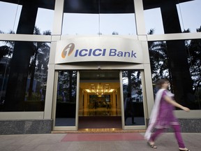 A woman walks past an entrance of ICICI Bank Ltd.'s head office in Mumbai, India.