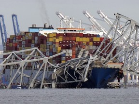 FILE - The cargo ship Dali is stuck under part of the structure of the Francis Scott Key Bridge after the ship hit the bridge, Tuesday, March 26, 2024, as seen from Pasadena, Md.