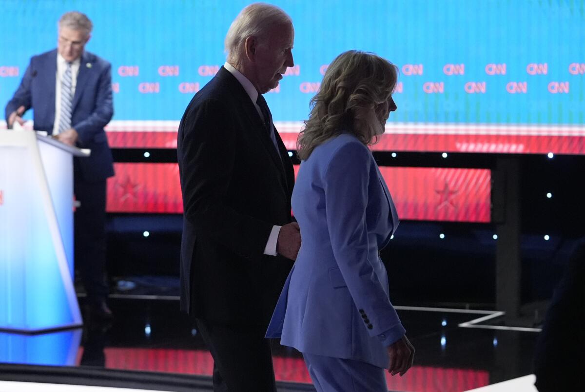 President Joe Biden, left, and First Lady Jill Biden depart following a presidential debate.